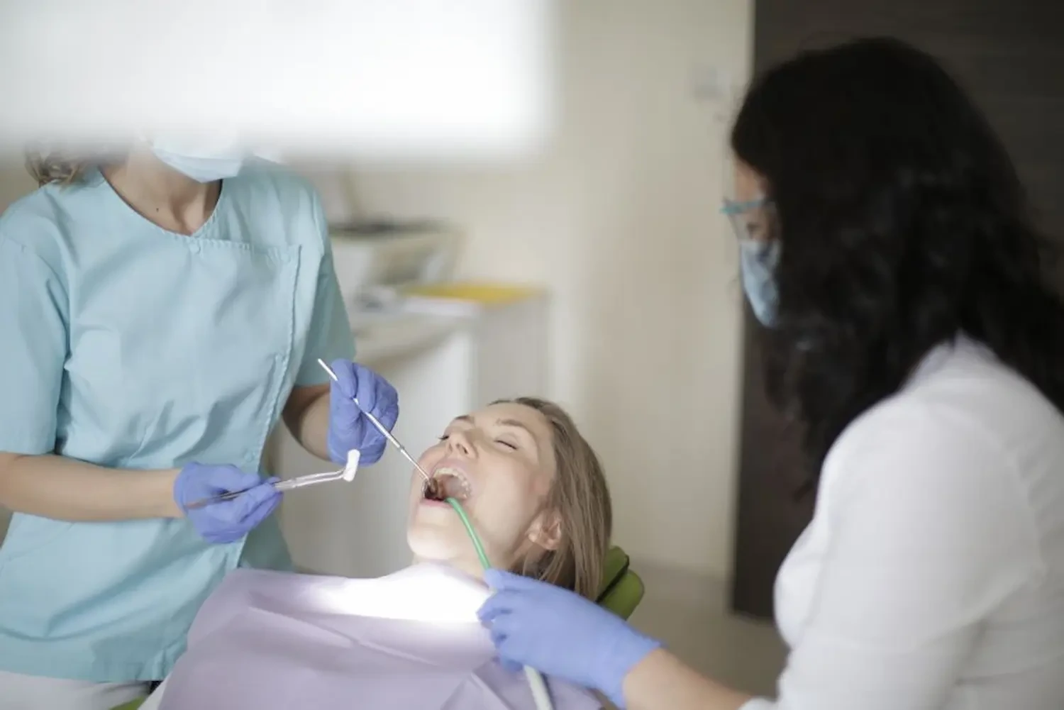 Emergency dentist in Crestwood, KY carrying out an urgent dental exam for a patient in pain
