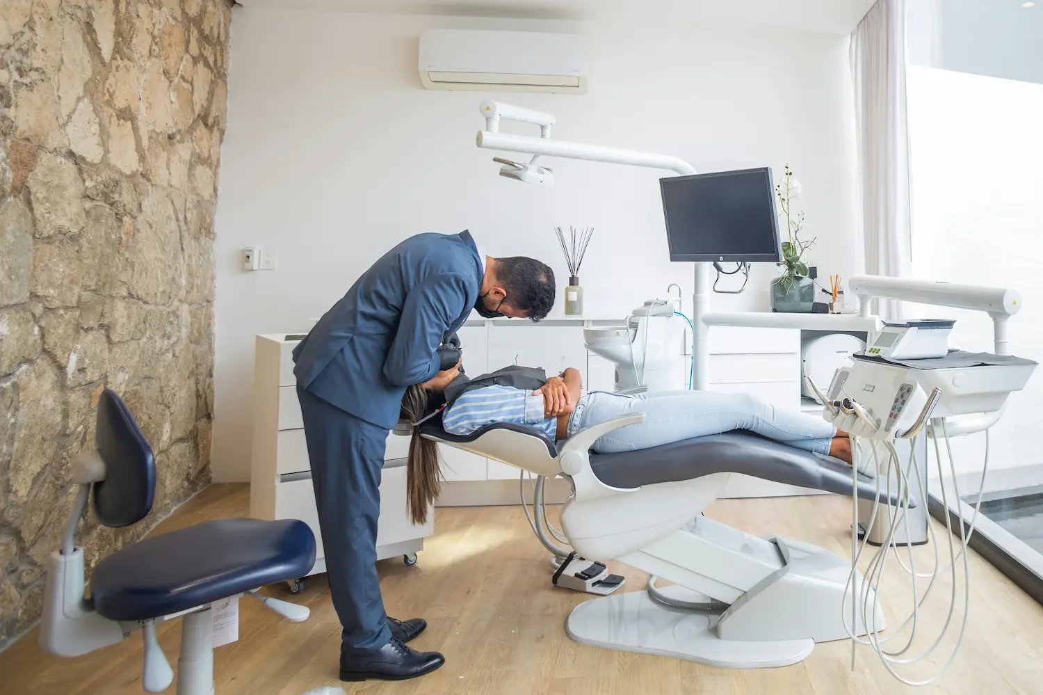 Emergency dentist in St. Matthews, KY examining a patient during a same-day emergency appointment